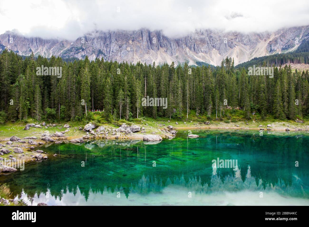 Karersee (Lago di Carezza) with Latemar Mountain Range in the Background Stock Photo