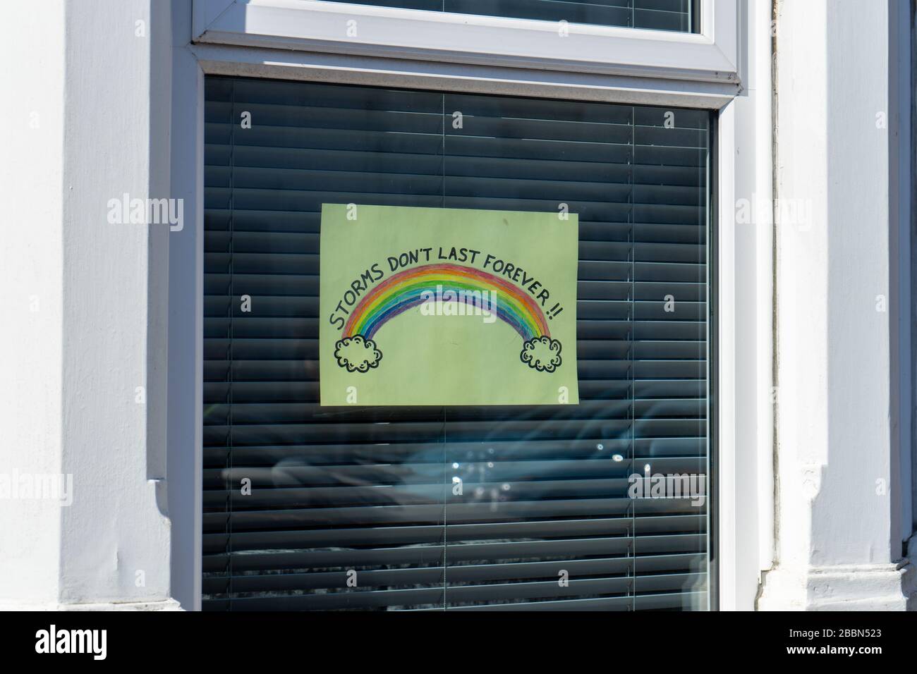 A Rainbow placed in the window of a house by children support of the NHS during the Covid-19 or Coronavirus pandemic Stock Photo