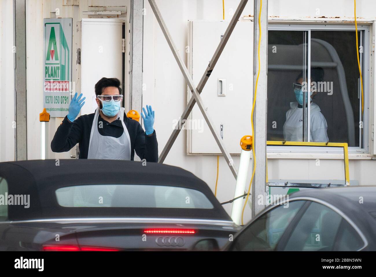 Medical staff at an NHS drive through coronavirus disease (COVID-19) testing facility in an IKEA car park, Wembley as the UK continues in lockdown to help curb the spread of the coronavirus. Stock Photo