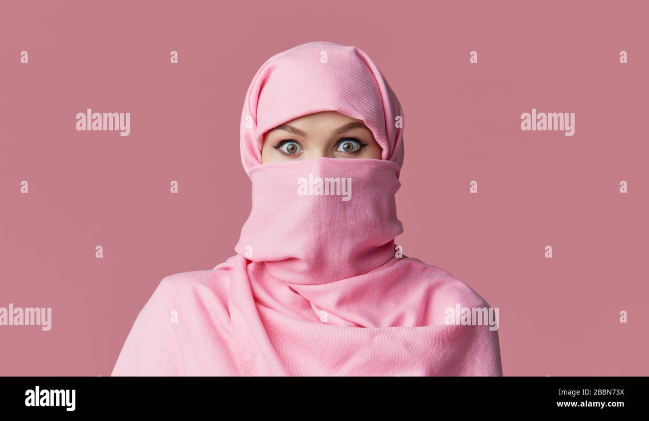 Portrait of young Muslim arabian woman wearing colorful hijab against ...