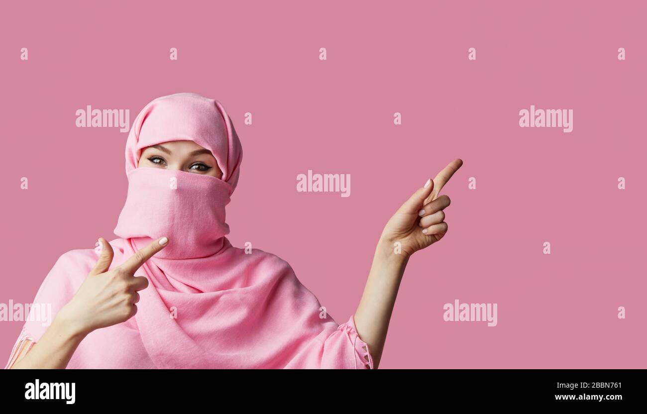 Portrait of young Muslim arabian woman wearing colorful hijab against ...