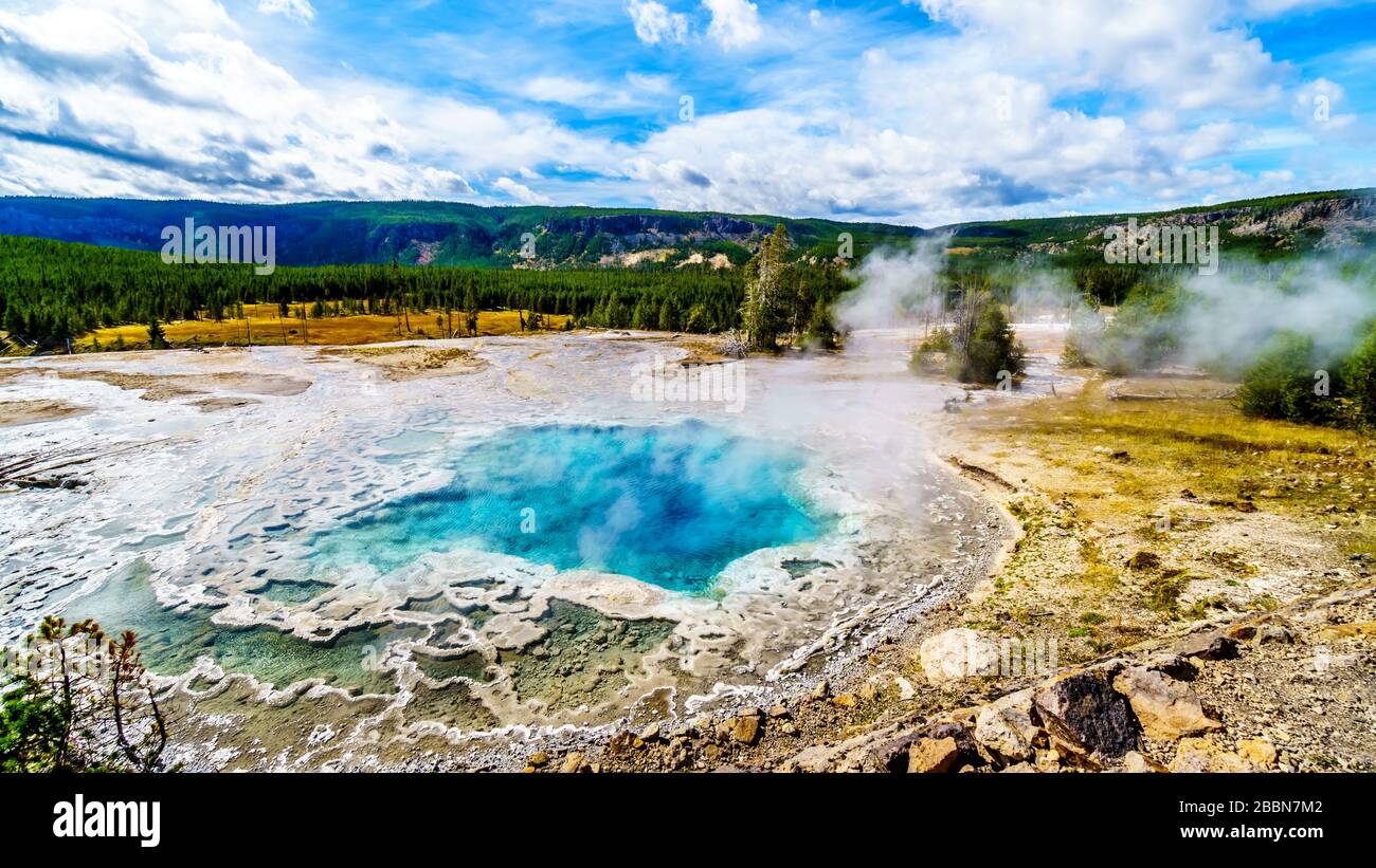 Steam coming from the turquoise waters of the Artemisia Geyser hot spring in the Upper Geyser Basin along the Continental Divide Trail in Yellowstone Stock Photo