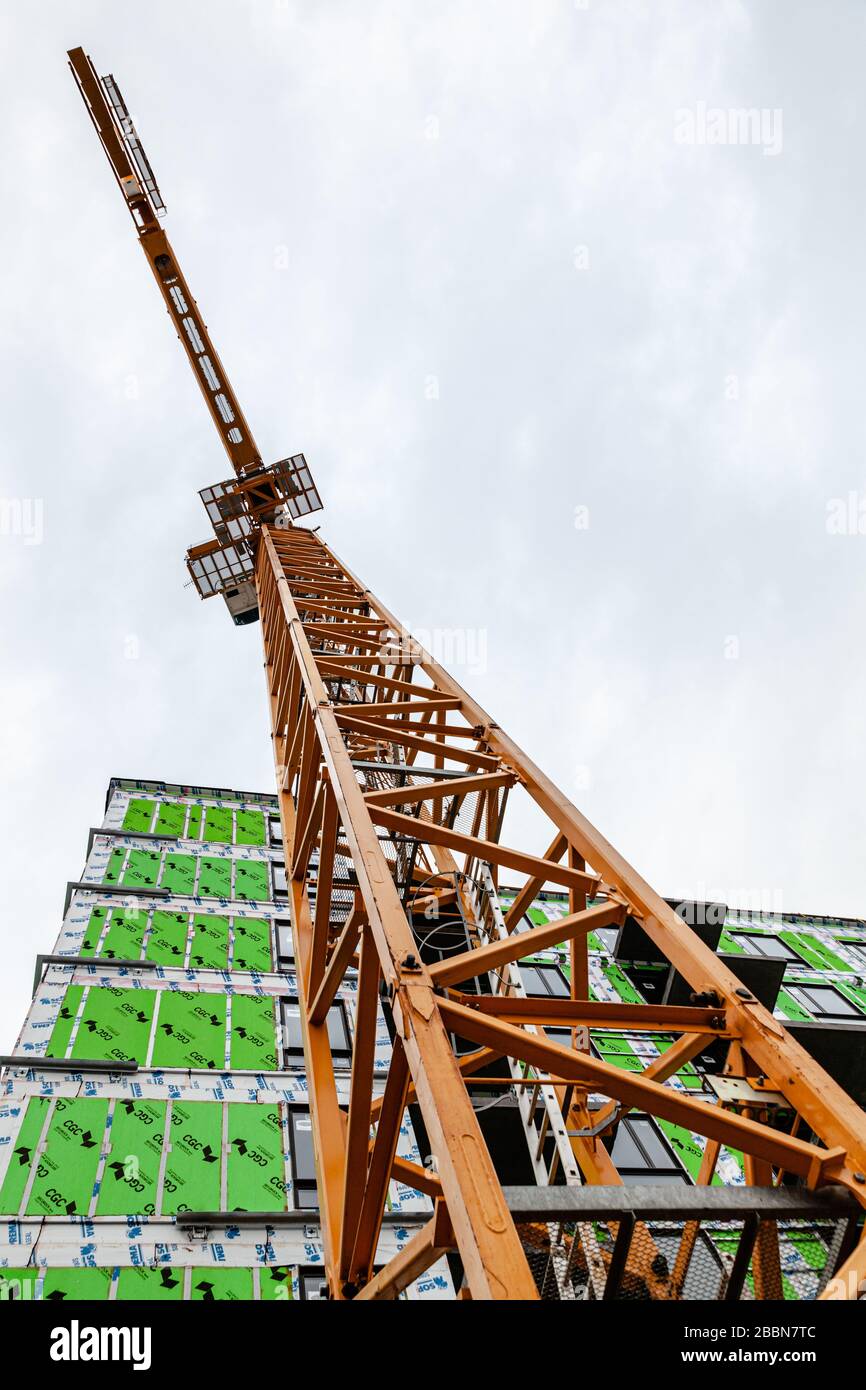 A crane viewed from below on a construction site. Stock Photo