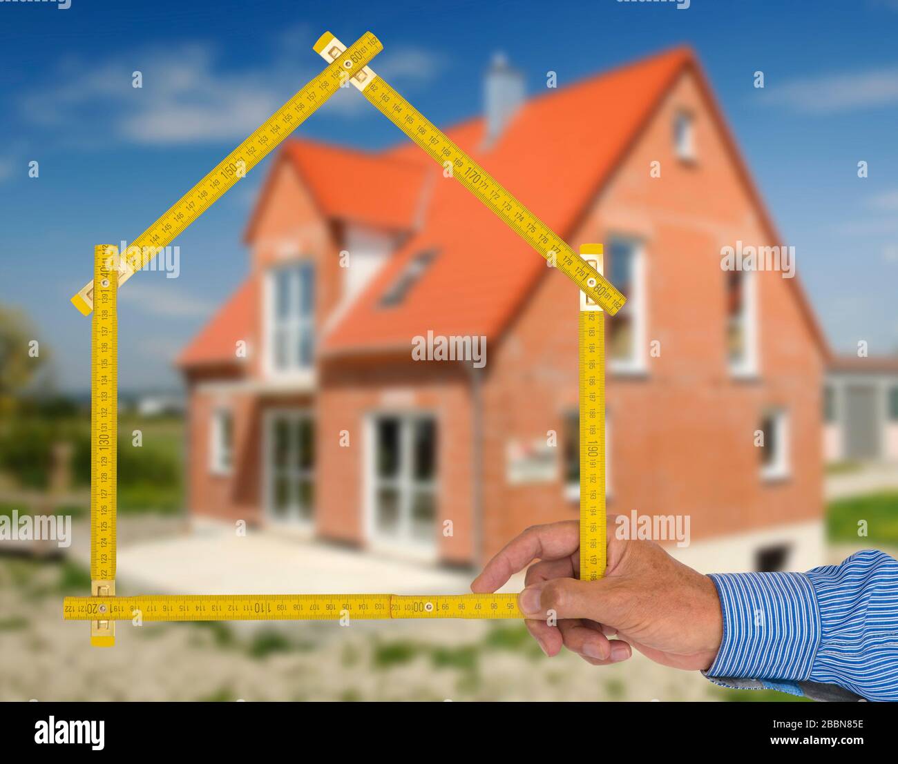 Real estate agent presents a newly built house for purchase Stock Photo