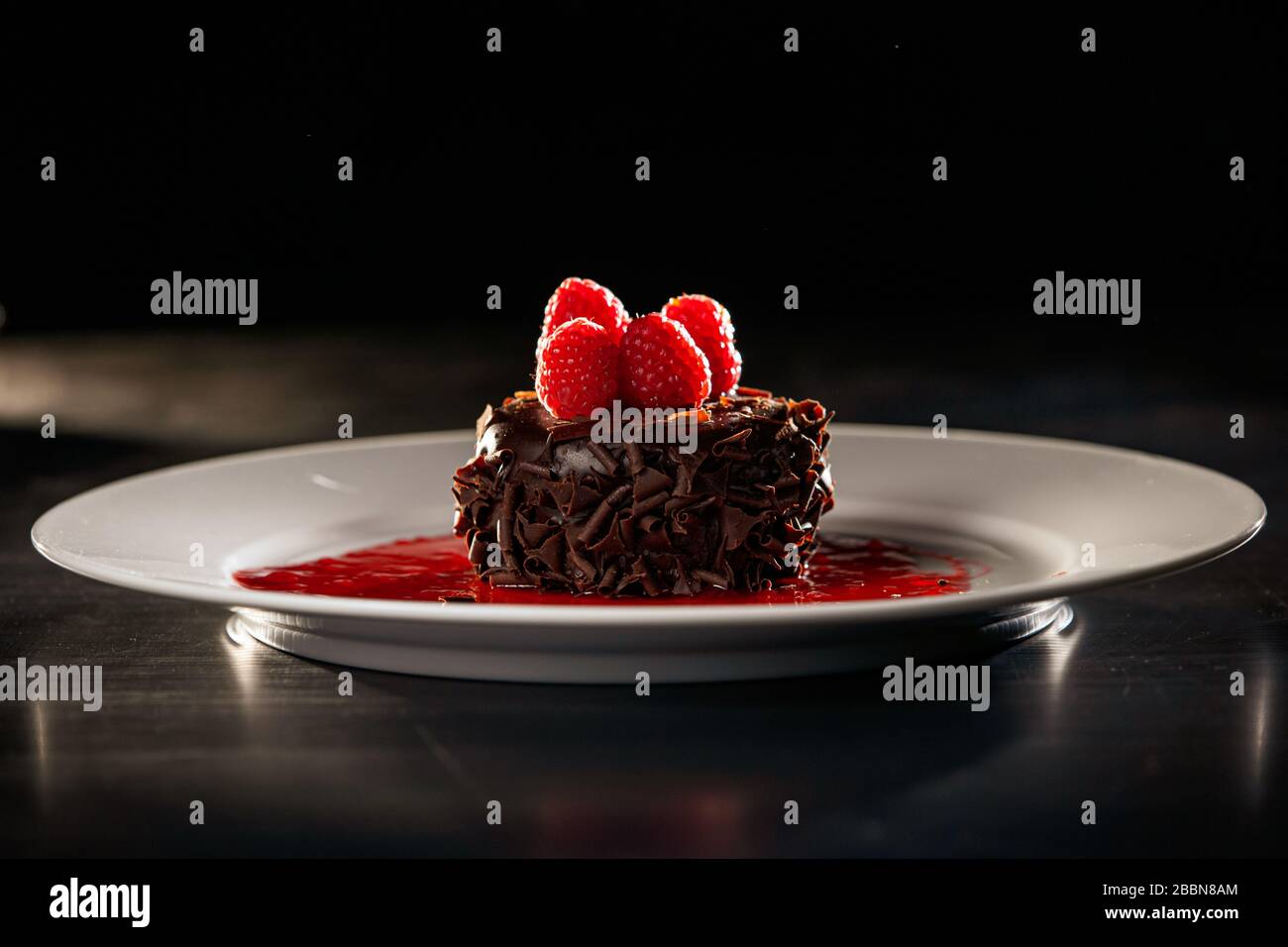 Chocolate cupcake dessert with raspberry sauce Stock Photo Alamy