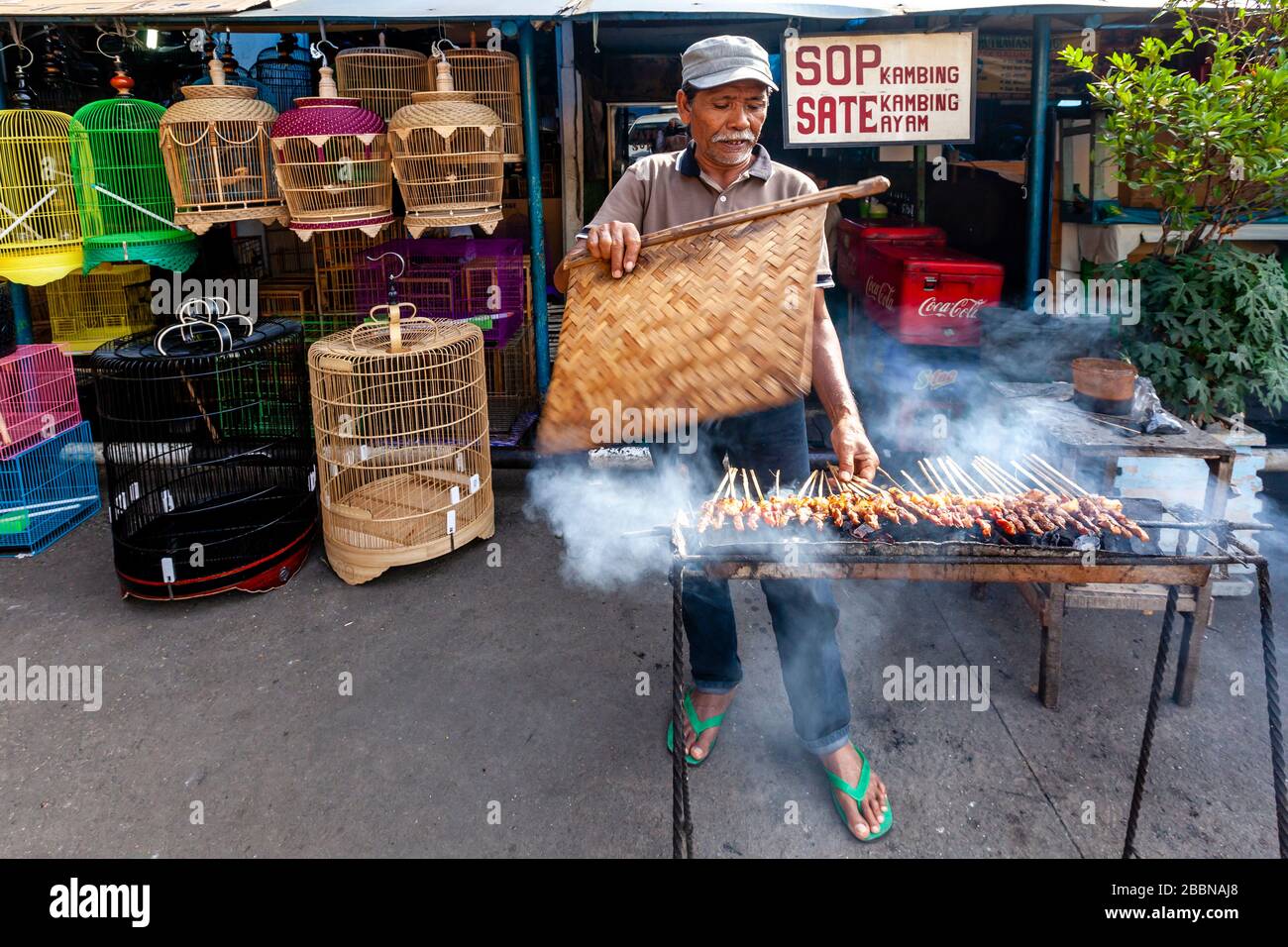 An Indonesian Man Cooking/Grilling Meat In The Street, Jakarta