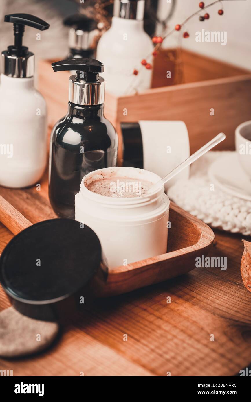 Natural Spa, Scrub, peeling with sea salt and sugar Still life. Organic spa cosmetic products and natural skincare concept on dark wooden background Stock Photo