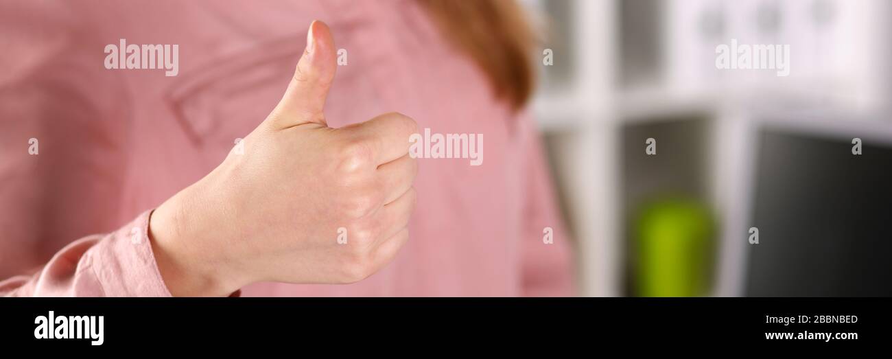 Girl in business clothes shows approval gesture Stock Photo