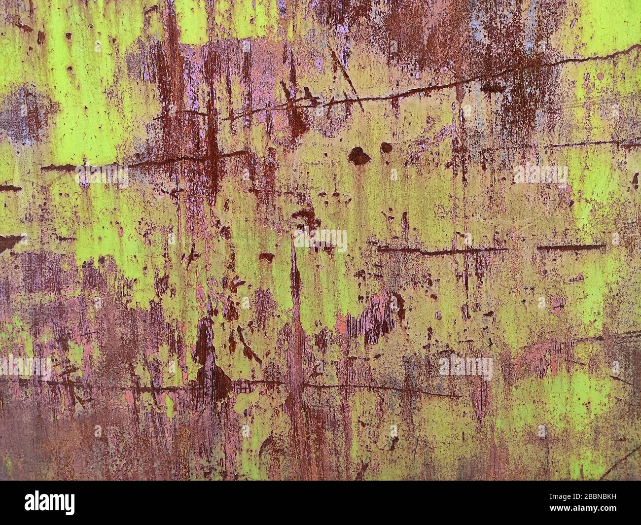 Corroded metal background. Rusted white painted metal wall. Rusty metal background with streaks of rust. Rust stains. The metal surface rusted spots. Stock Photo