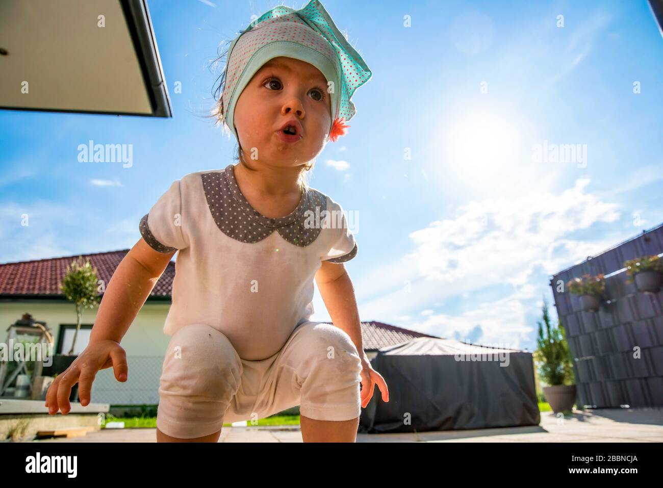 Portrait of very sweet little child with big eyes. 1 year old baby girl. Stock Photo