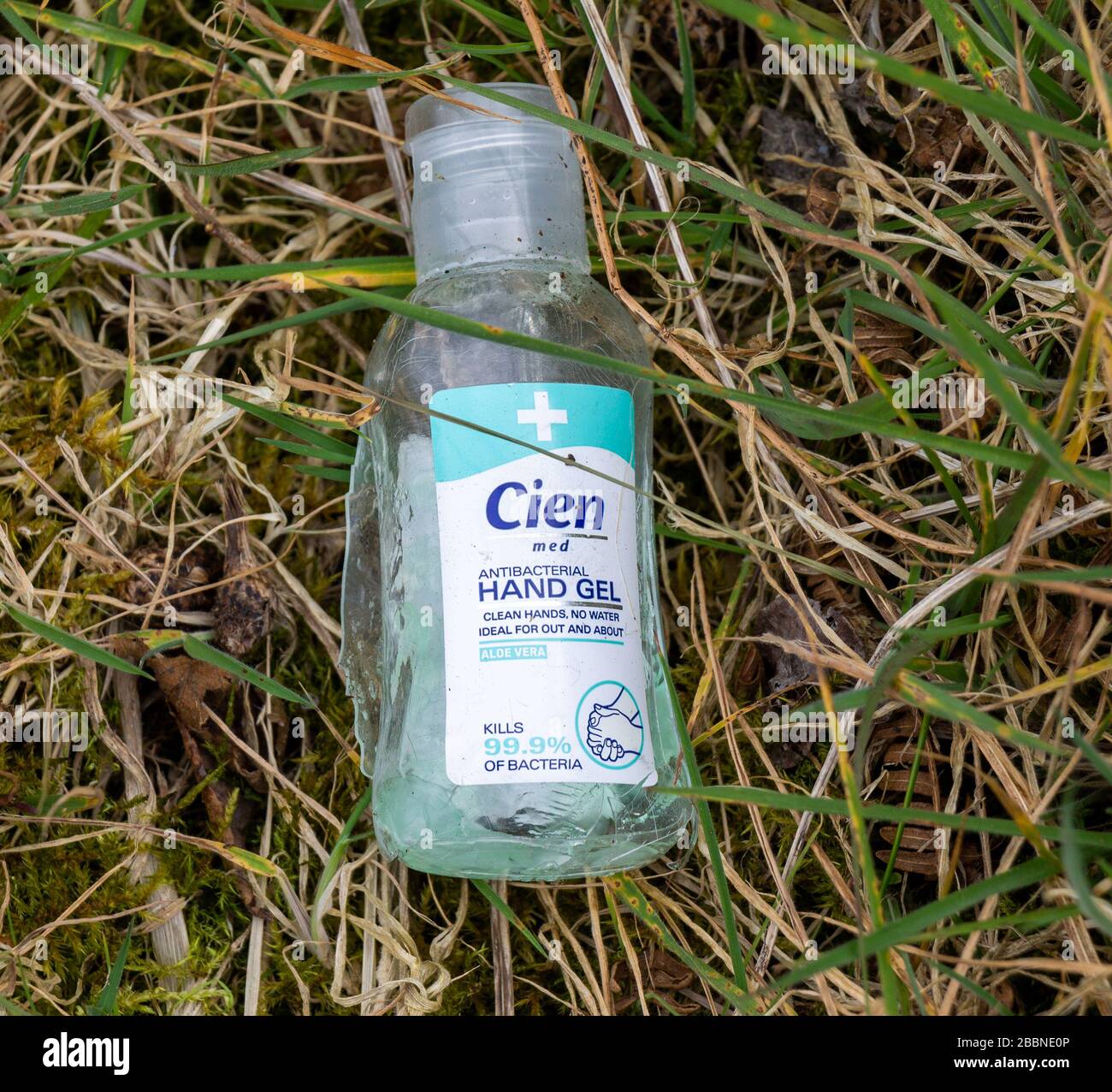 Empty plastic bottle of Hand Sanitiser thrown on the ground. Stock Photo