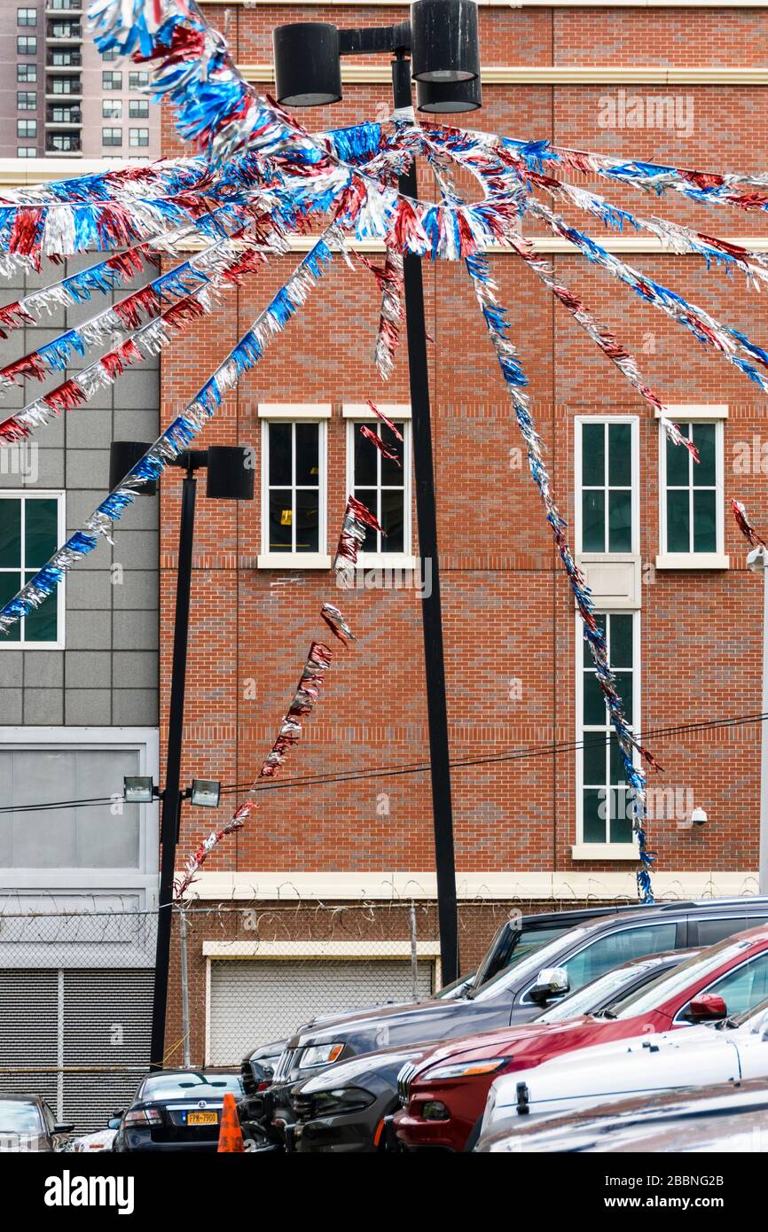 Red white and blue bunting over a parking lot in New York Stock Photo