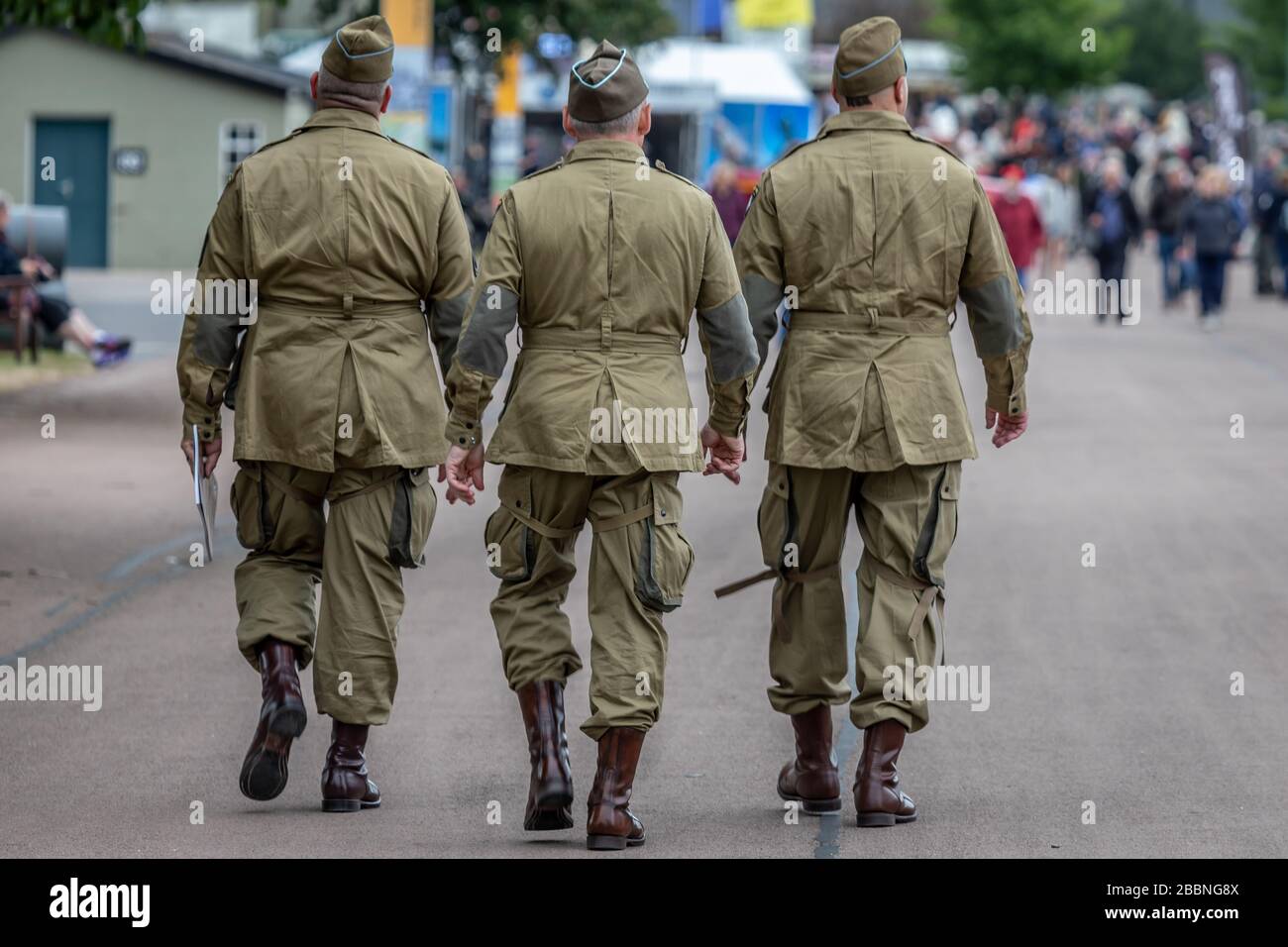 Three Soldiers go for a walk during the Daks over Normandy event at IWM Duxford, Duxford Airfield, Cambridgeshire, UK Stock Photo