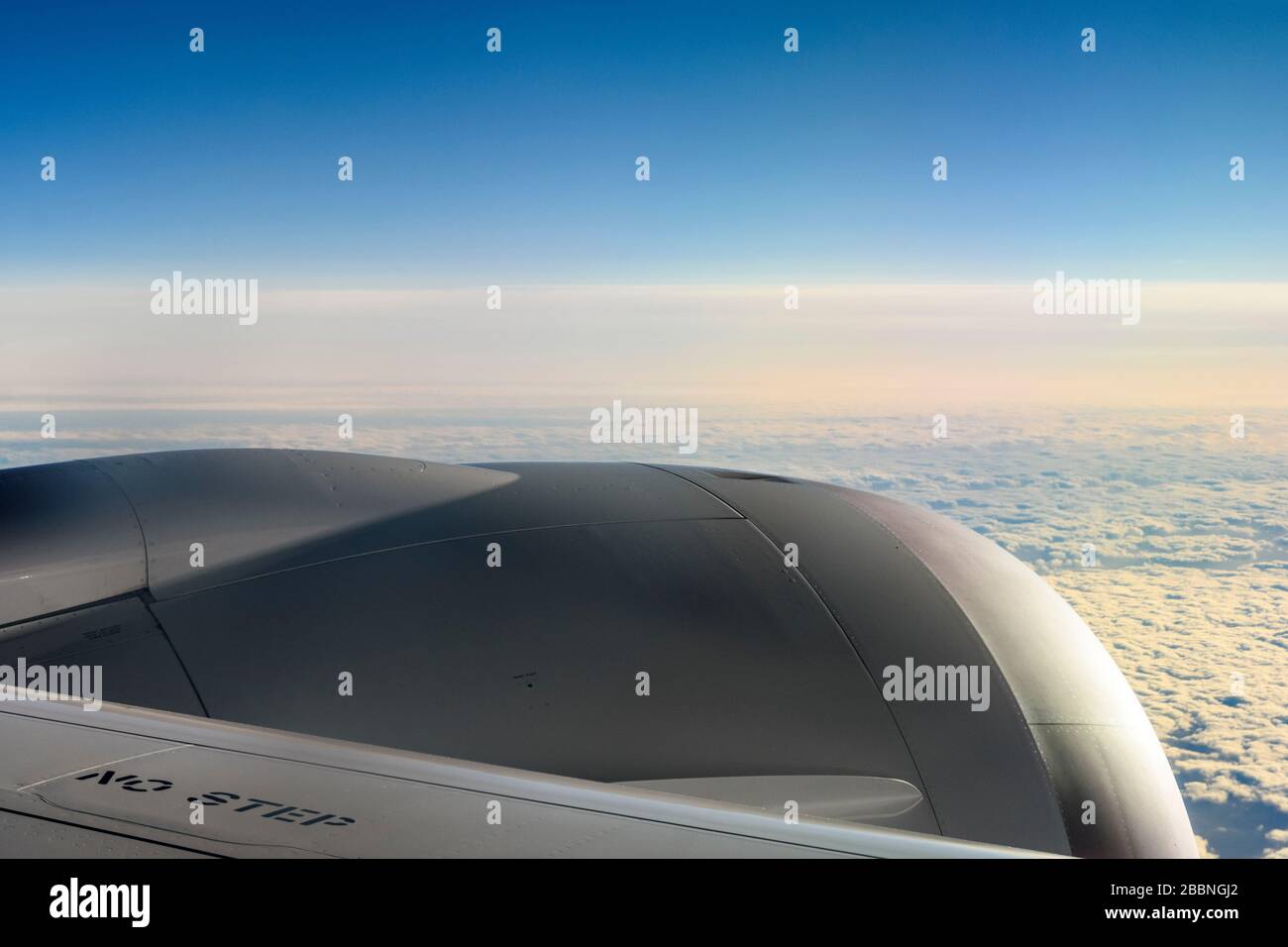 In flight view looking across a Boeing 787 Dreamliner engine high above the clouds Stock Photo
