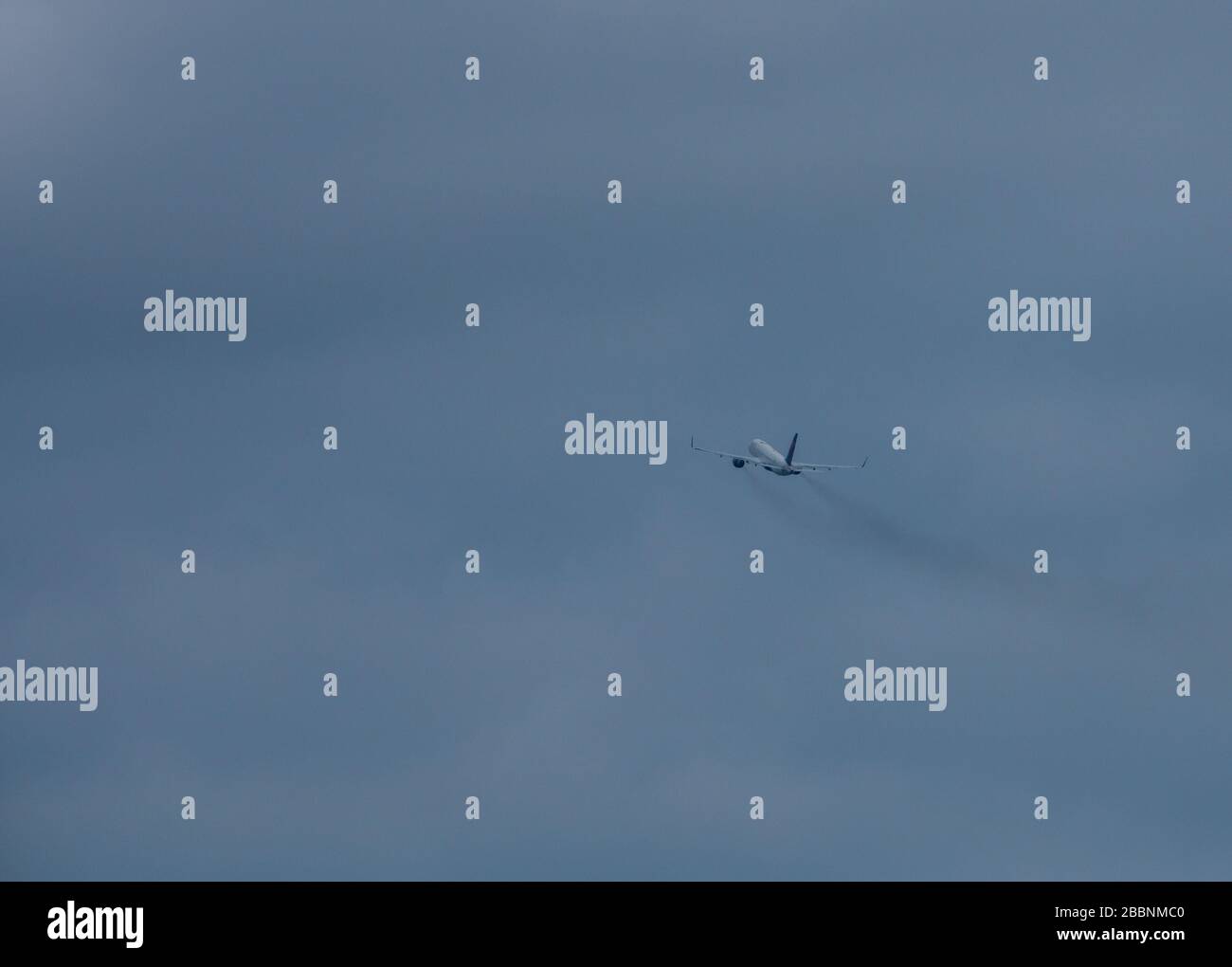 An Delta Airlines airplane takes off into cloudy skies at Orlando International Airport on Thursday March 26 at 12:27pm. Due to Covid-19 very few people could be seen at the 10th busiest airport in the U.S. Stock Photo