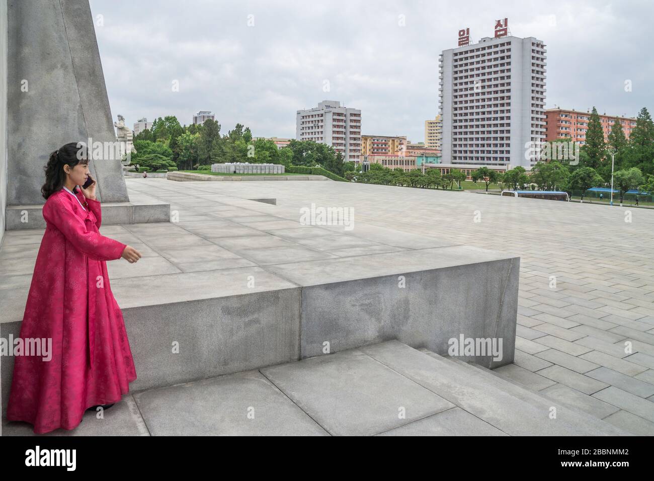 A North Korean woman wearing a traditional dress is seen at the pedestal of the Tower of Juche, Pyongyang, North Korea Stock Photo