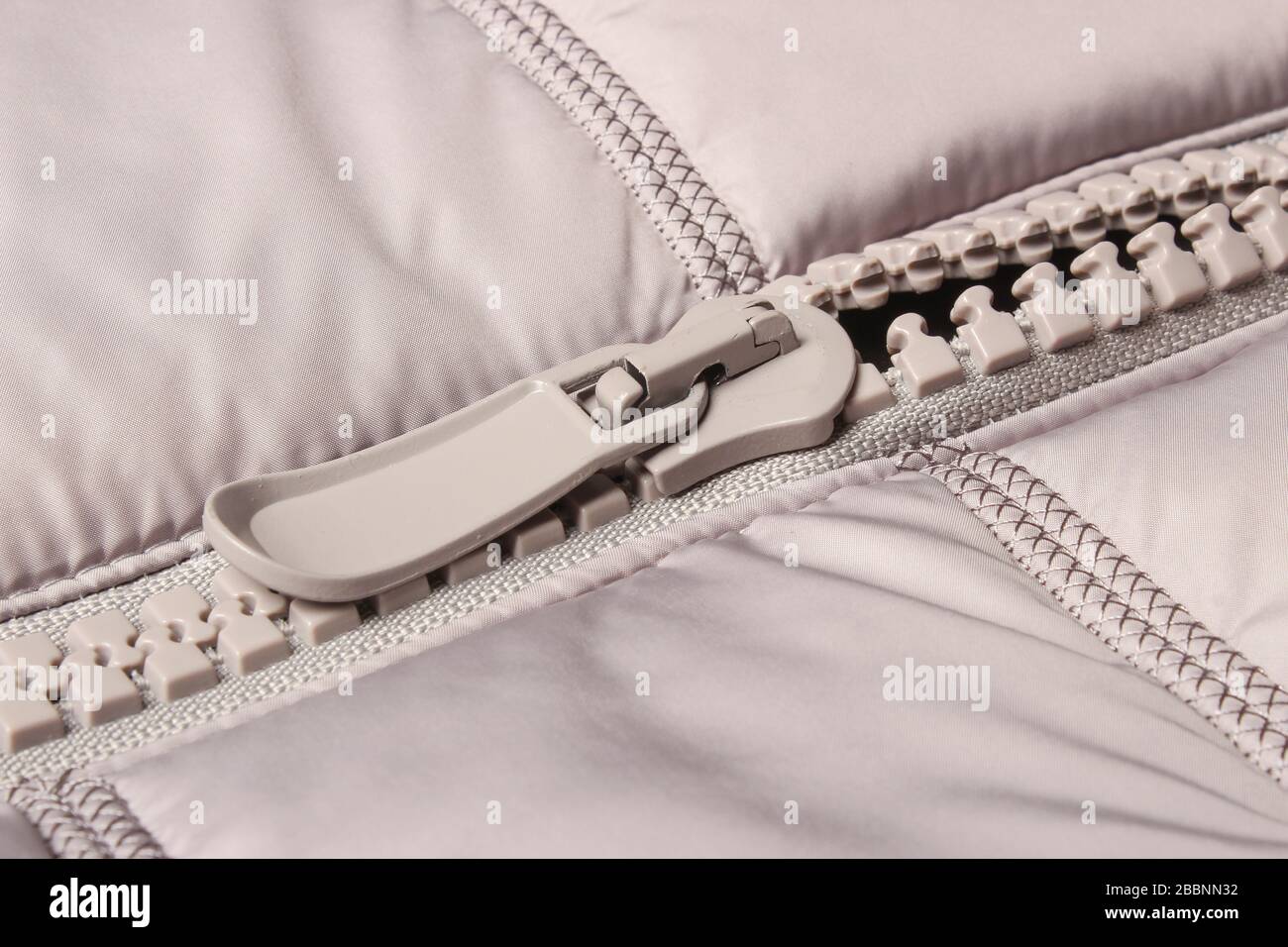 Gray plastic zipper on closes Stock Photo