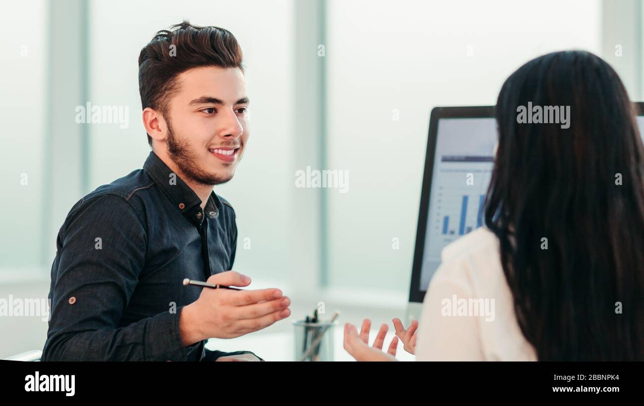 rear view. two employees discuss work issues sitting at the off Stock Photo