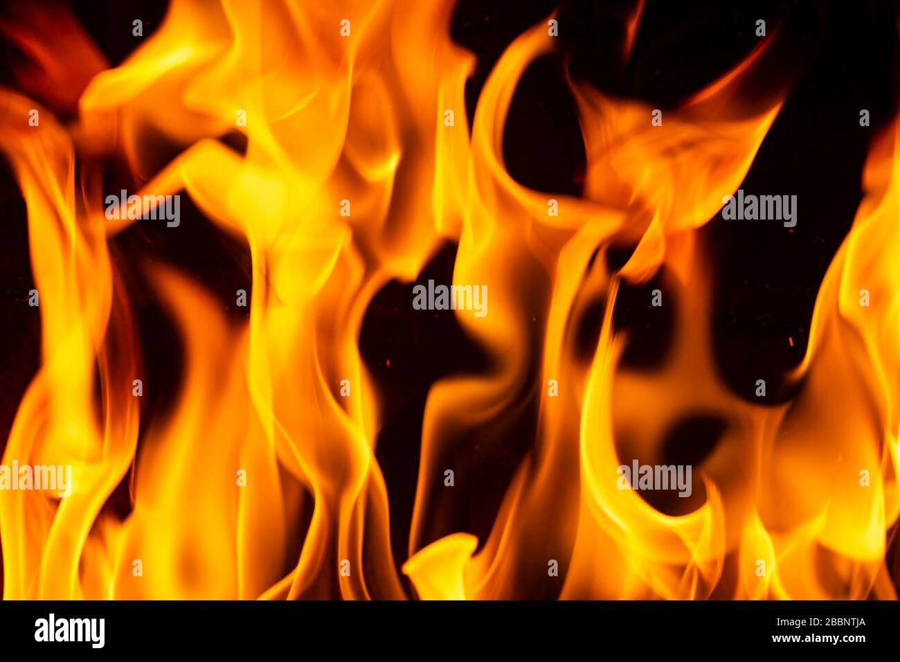 Close up on flamme burning in the fireplace during a cold winter night Stock Photo