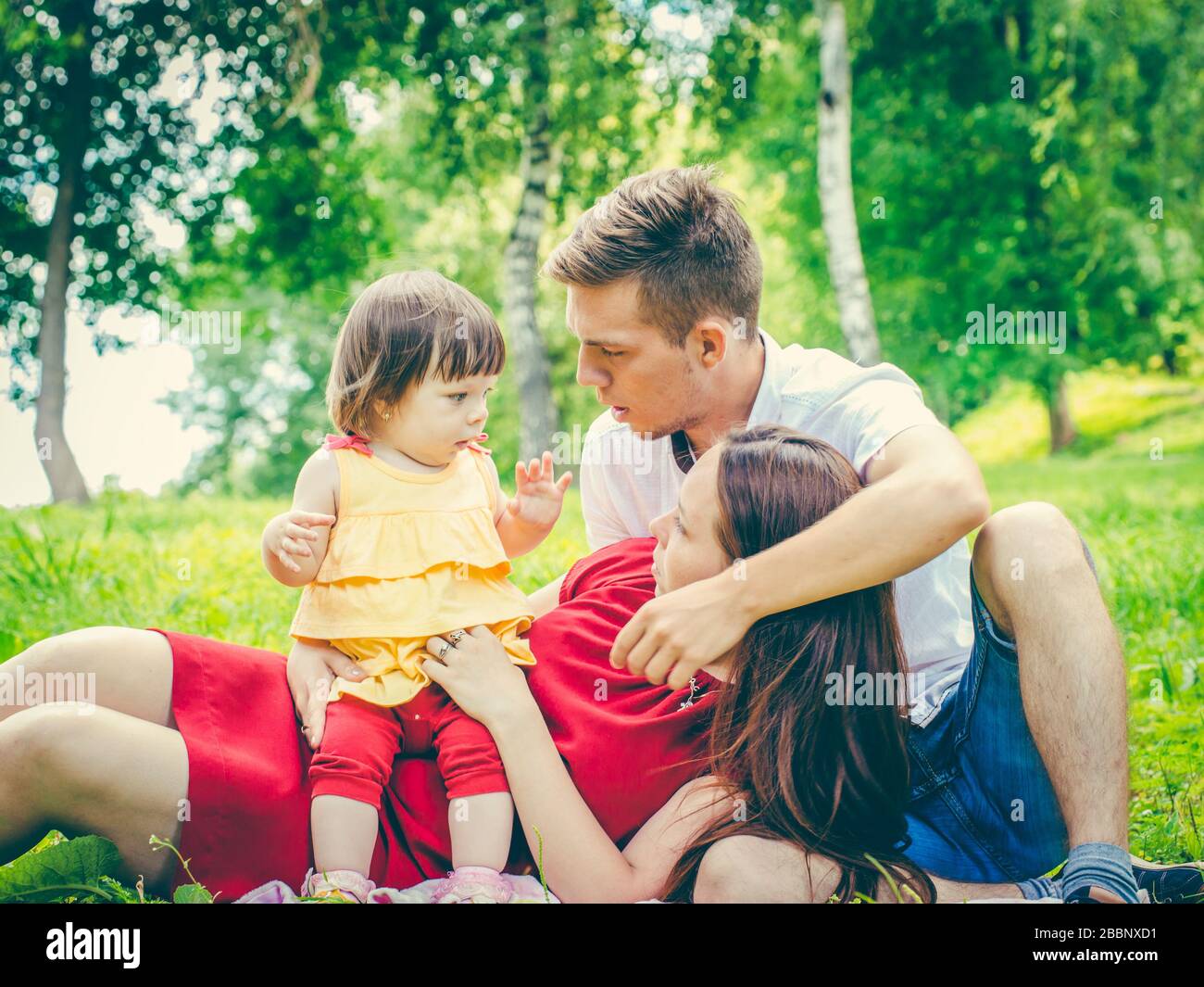 naughty little baby and parents with tired and discontented expression. Parents tired of baby concept Stock Photo