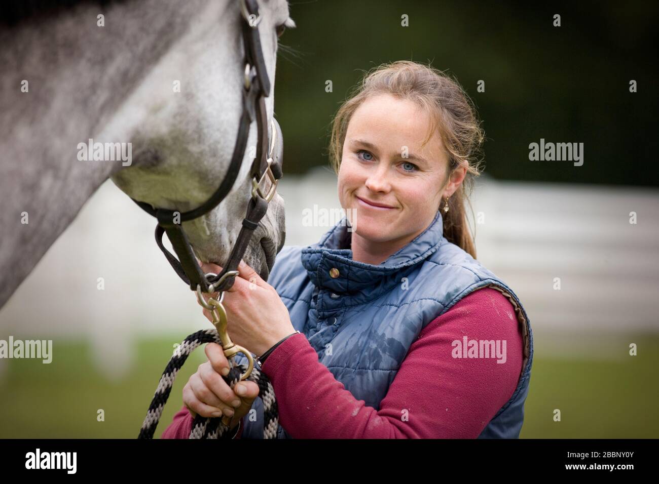 Portrait of a young woman standing with her horse Stock Photo