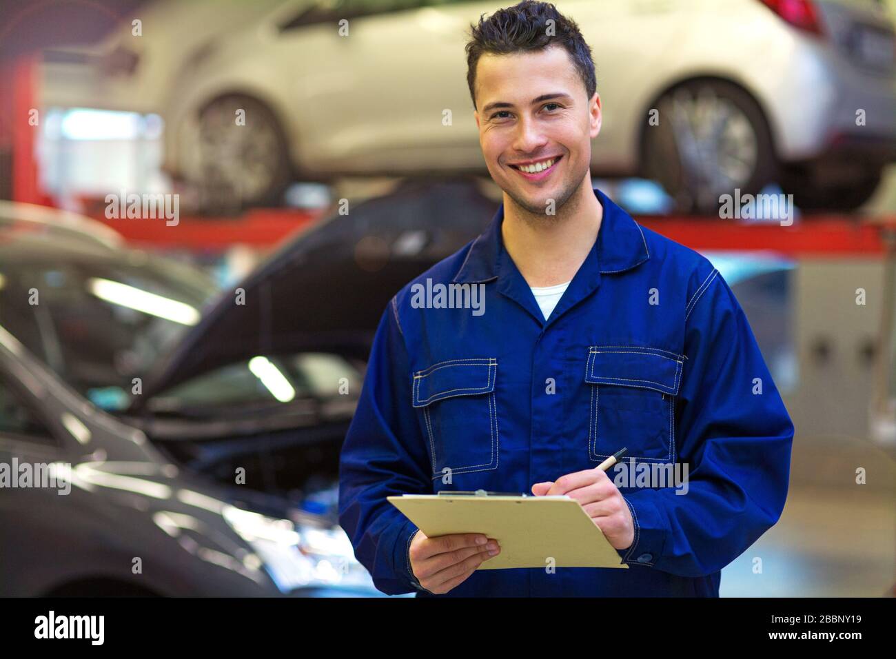 Mechanic working in auto repair shop Stock Photo - Alamy