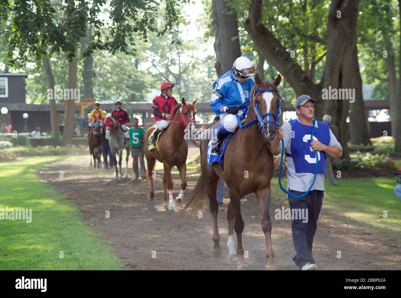 Post parade of jockeys and horses through the paddock Stock Photo