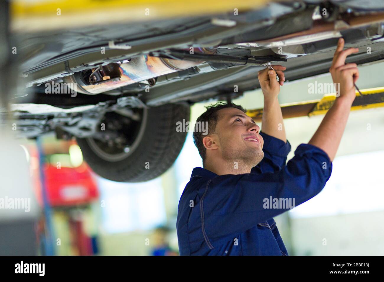 Mechanic working in auto repair shop Stock Photo - Alamy