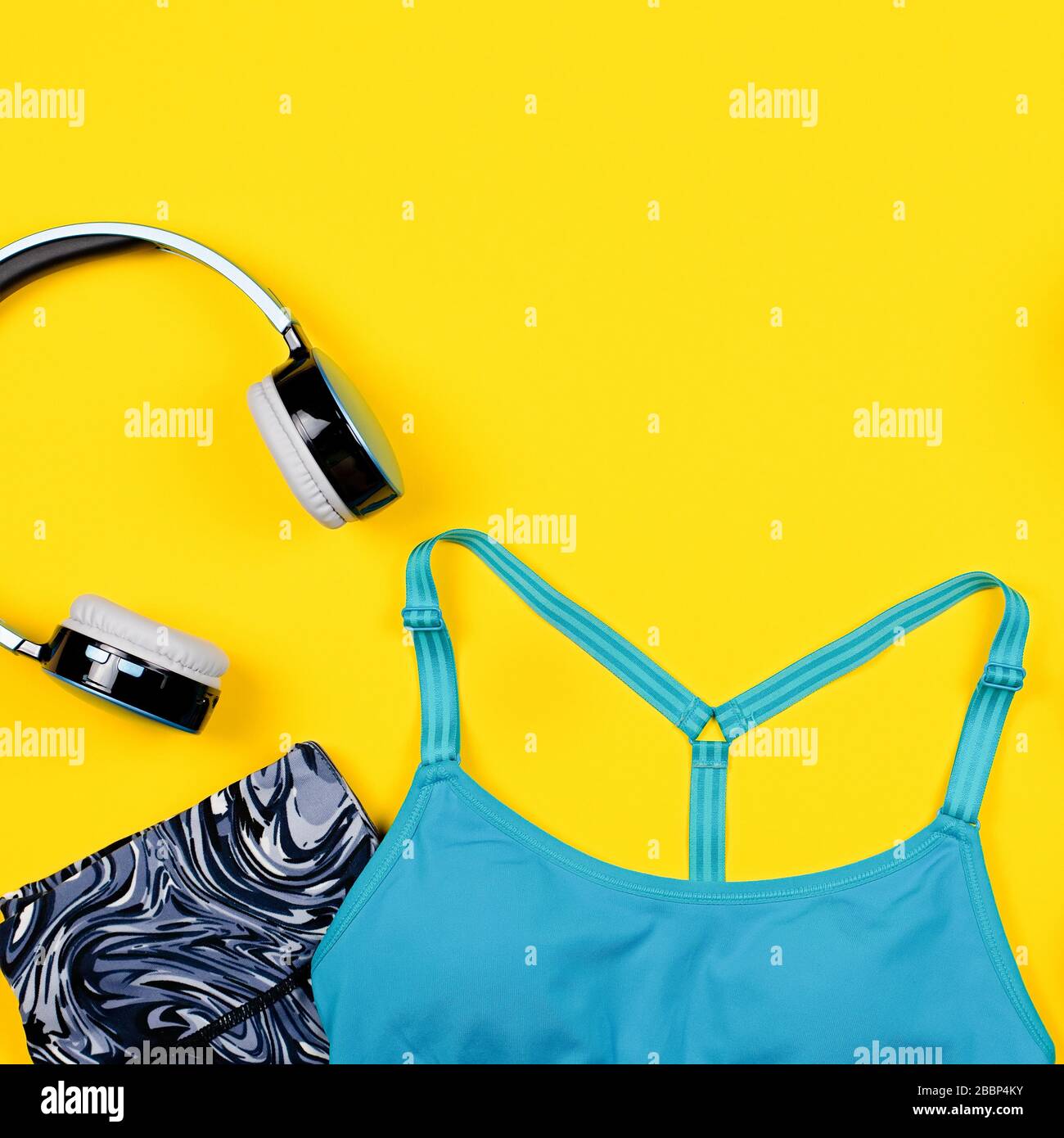 https://c8.alamy.com/comp/2BBP4KY/layout-of-sport-clothes-and-accessories-for-women-sports-bra-sneakers-headphones-on-yellow-background-top-view-2BBP4KY.jpg