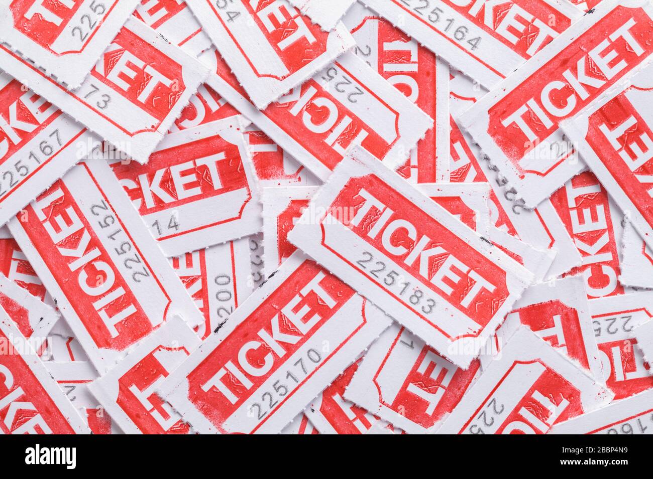 Red Tickets Laying in Large Pile Background. Stock Photo