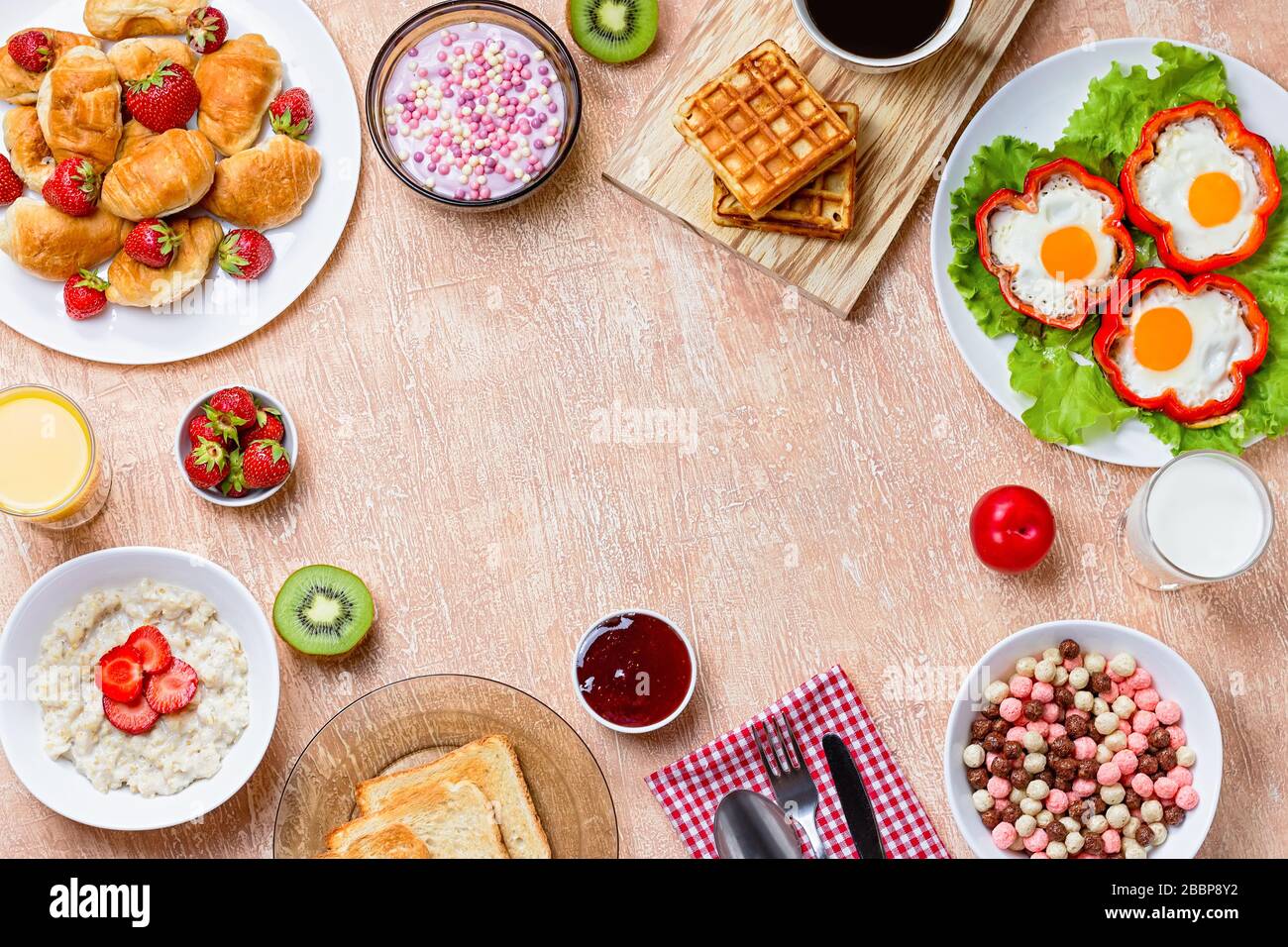 Continental breakfast with cereal, fried eggs, croissants, fruits and