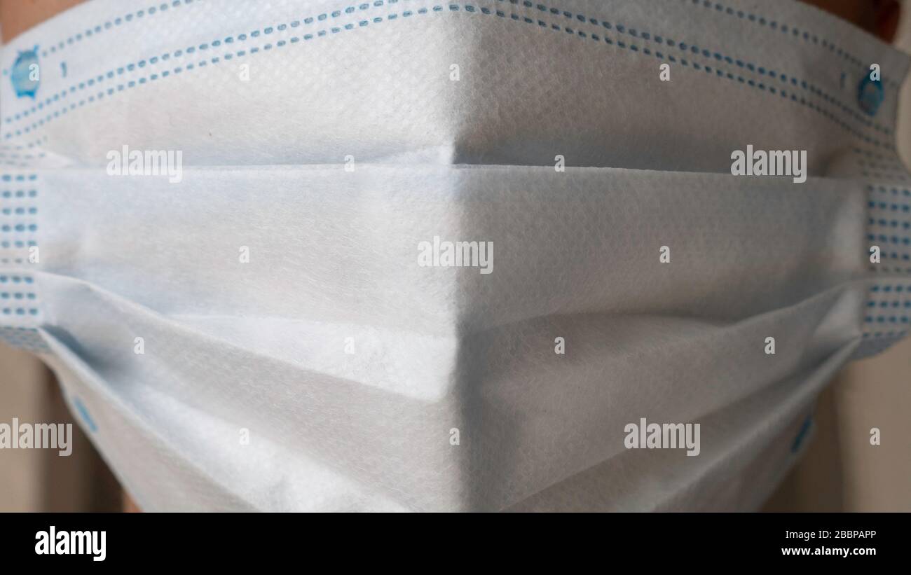 White medical mask on face - close up Stock Photo - Alamy