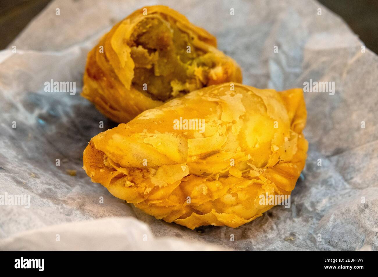 Traditional south east asian curry puff (deep fried pie filled with curry, chicken and potates) Stock Photo