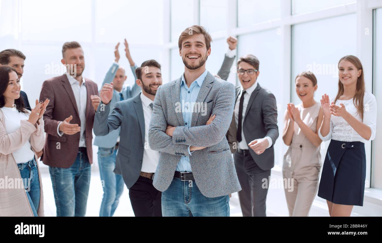smiling entrepreneur on the background of jubilant business team Stock Photo