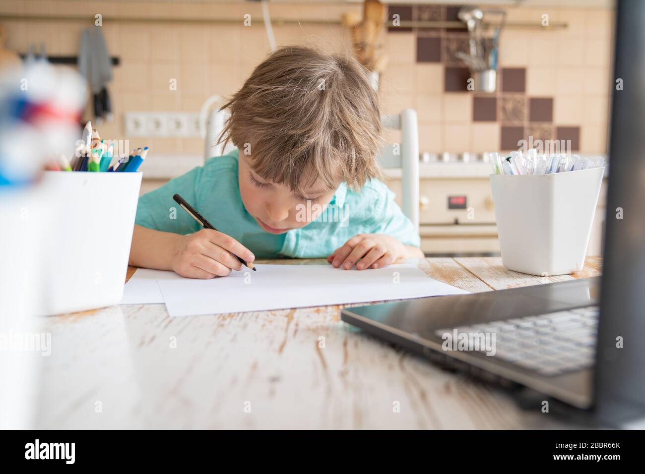 Covid lockdown - boy learns to draw online during self-isolation Stock Photo