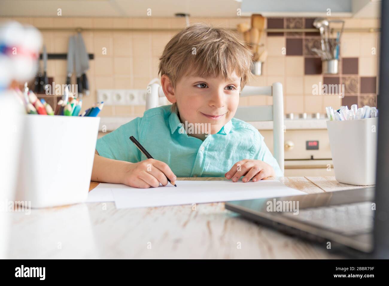 Covid lockdown - boy learns to draw online during self-isolation Stock Photo