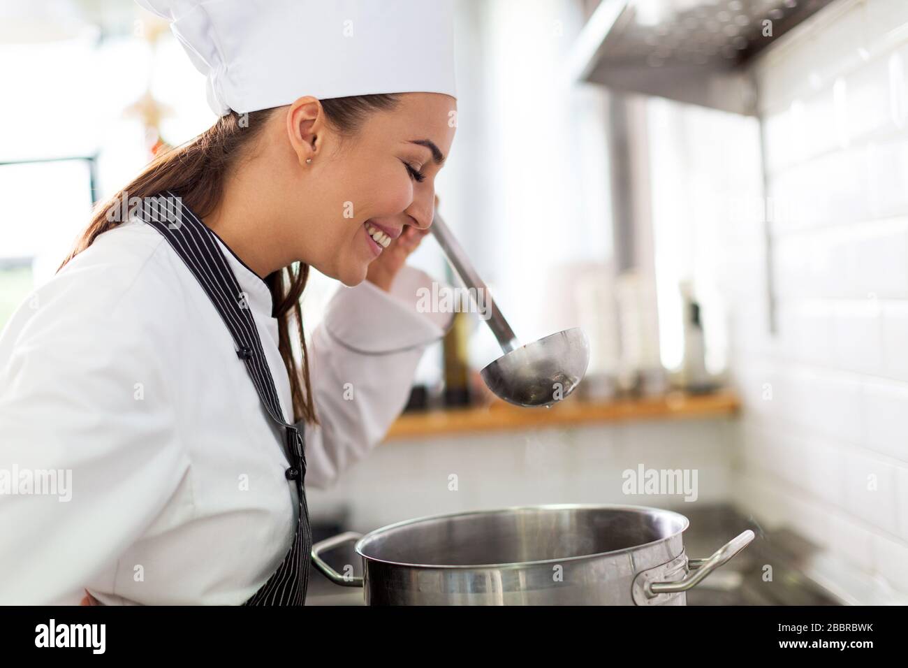 Female chef in kitchen Stock Photo