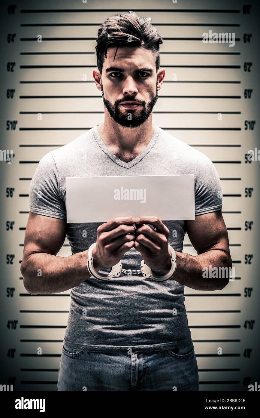 A mug shot of a prisoner with blank information card and handcuff Stock Photo