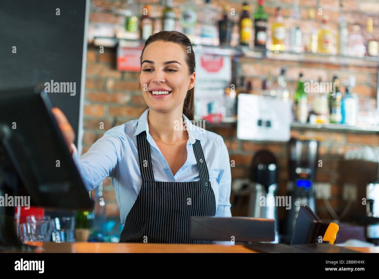 Woman working at cafe Stock Photo