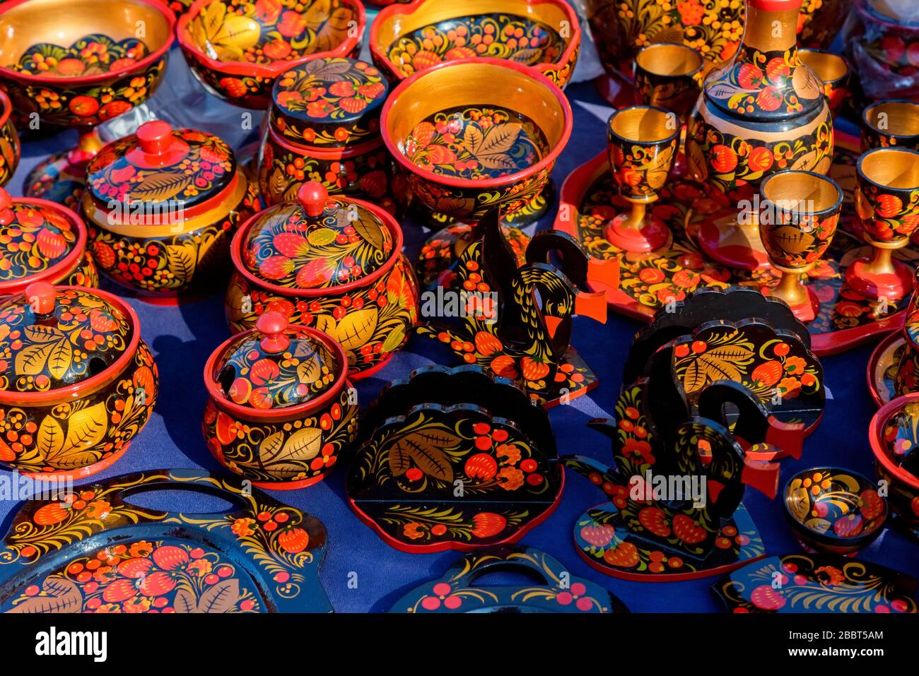 Collection of russian traditional wooden utensil in Khokhloma painting