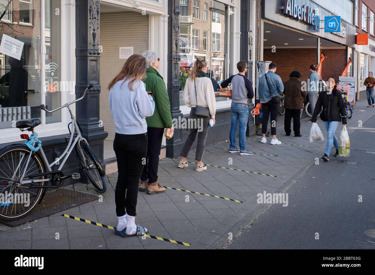Corona measures: social distancing at the entrance of supermarket Albert Heijn (owned by Ahold) in Utrecht, Netherlands. Stock Photo