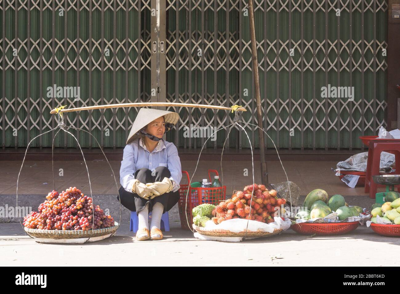 Dalat market - Woman vendor selling fresh fruit at the main market in Dalat, Vietnam, Southeast Asia. Stock Photo