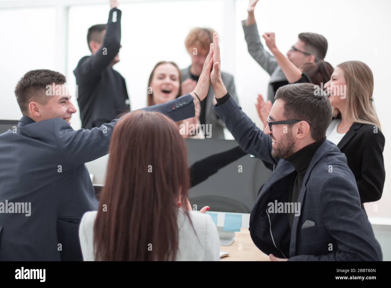 group of young business people giving each other a high five Stock ...