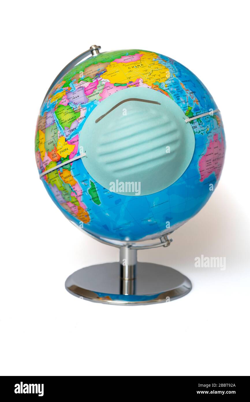 Health mask on a world earth globe to illustrate a pandemic Stock Photo