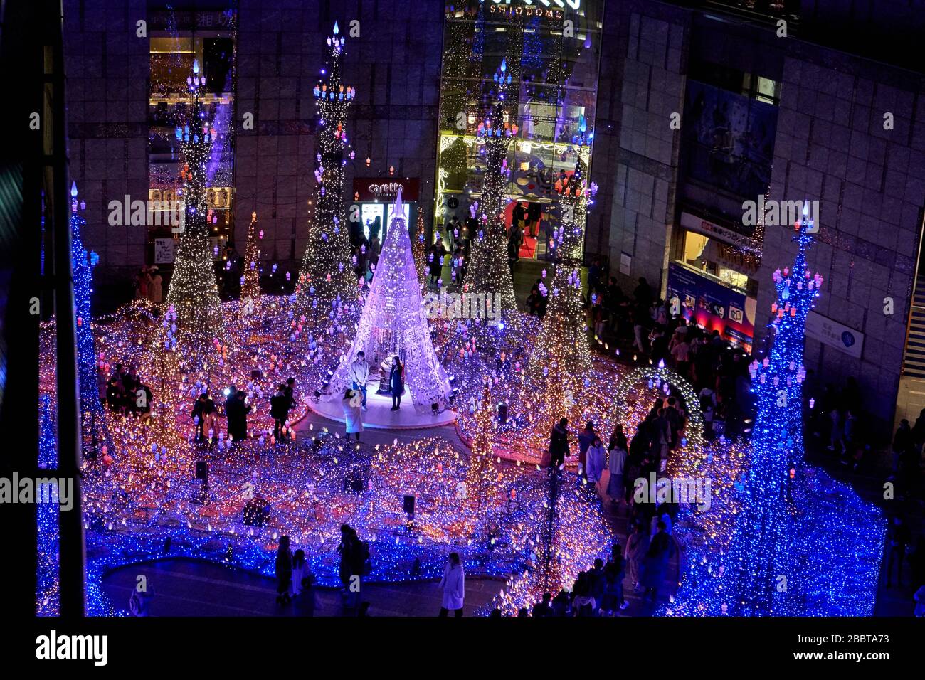 Blue christmas illumination surrounded by building Stock Photo