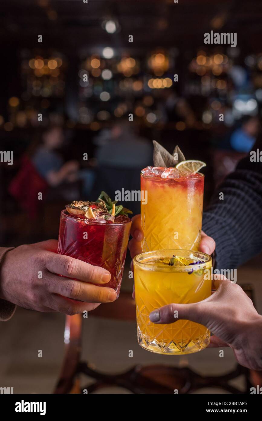 Toasts among friends to celebrate after work in a bar-restaurant. Stock Photo