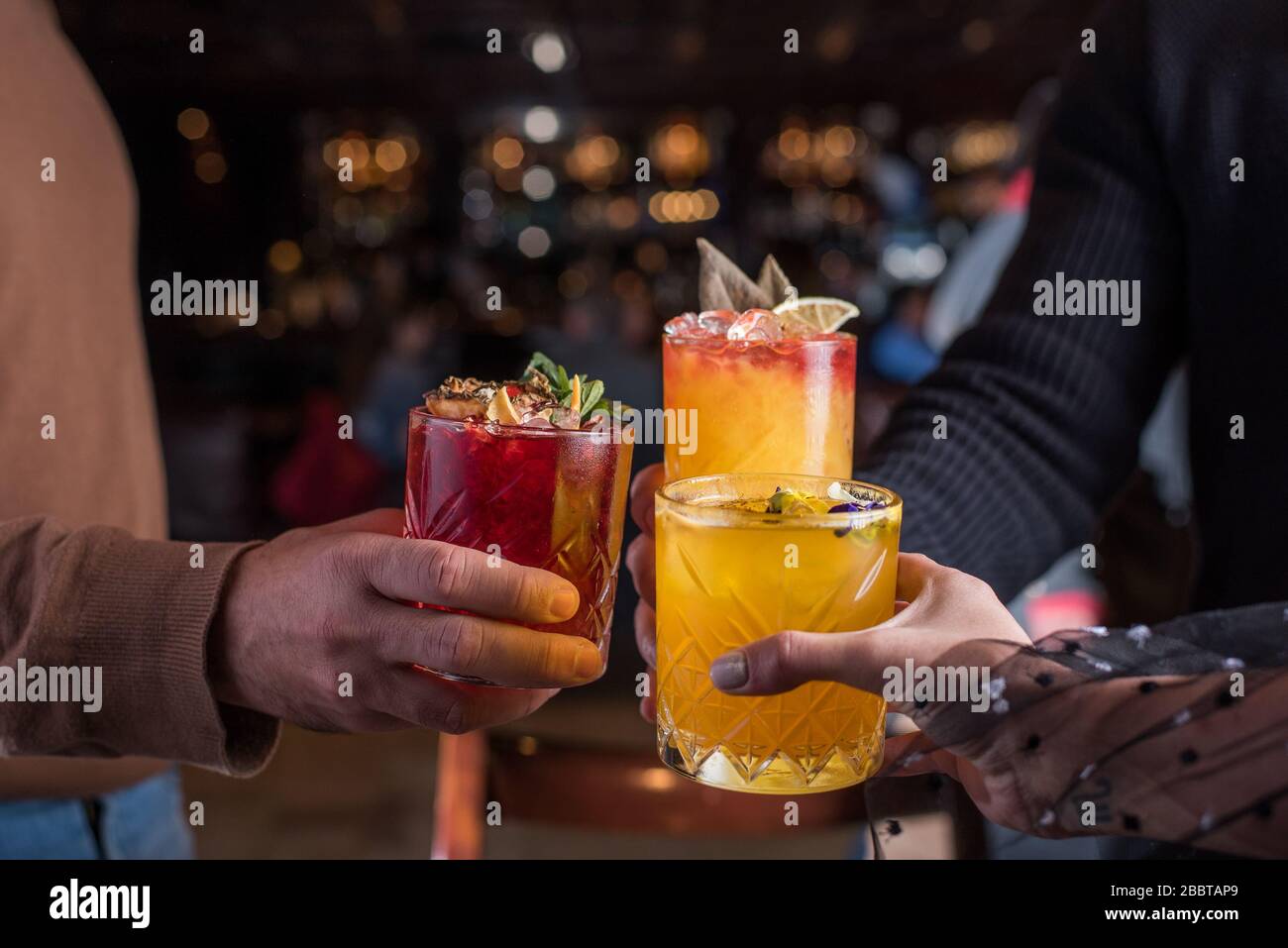 friends,cheers,cocktail,service,bar,drinks,retaurant,lifestyle,hands,glasses,mixology,hospitality,pub,art,dinner,party,night,celebration,anniversary,g Stock Photo