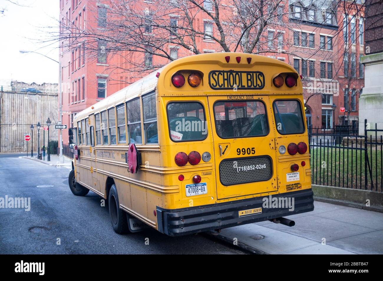 A parked yellow school bus in New York, Manhattan. Stock Photo