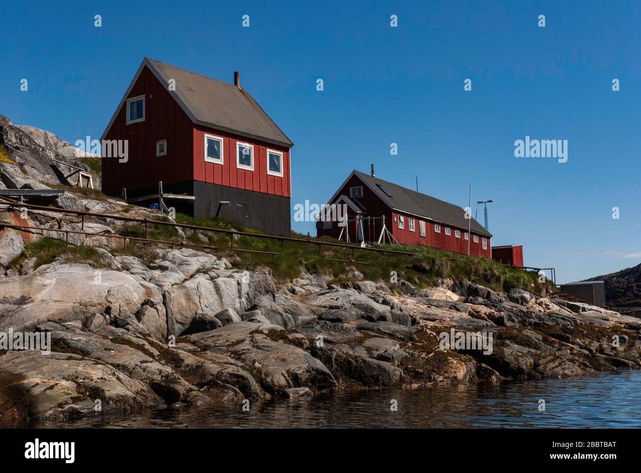 Colorful houses of the fishing town in Greenland. Mountains in the background. Stock Photo