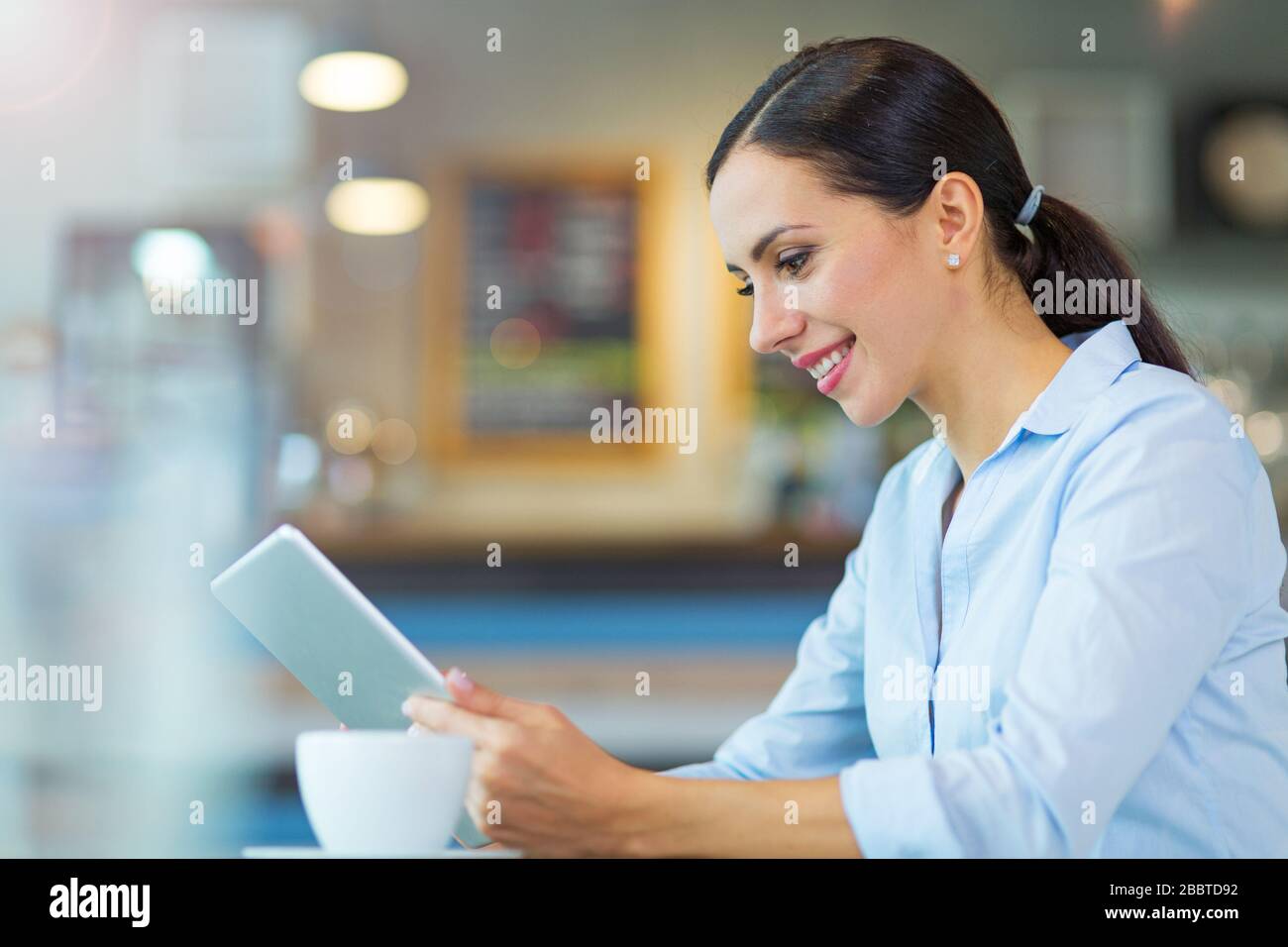 Young businesswoman working at cafe Stock Photo